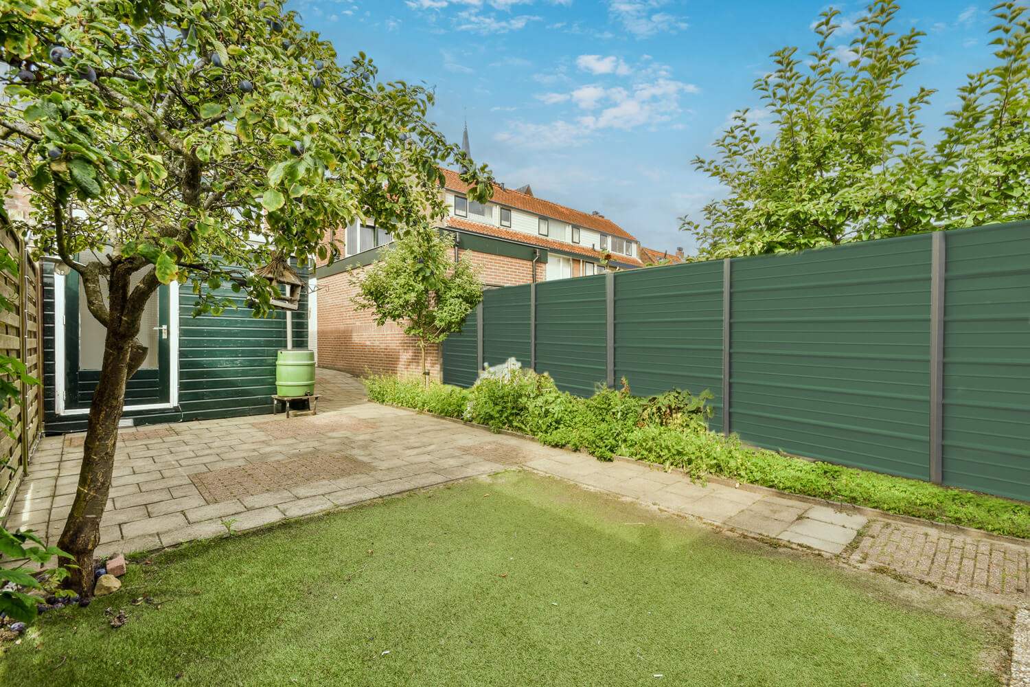 Backyard with a Beautiful Low-Maintenance Green FenSteel Fence Installed